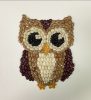 Mosaic owl made from various colors of beans