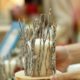 Decorate candles with silver and glitter twigs.